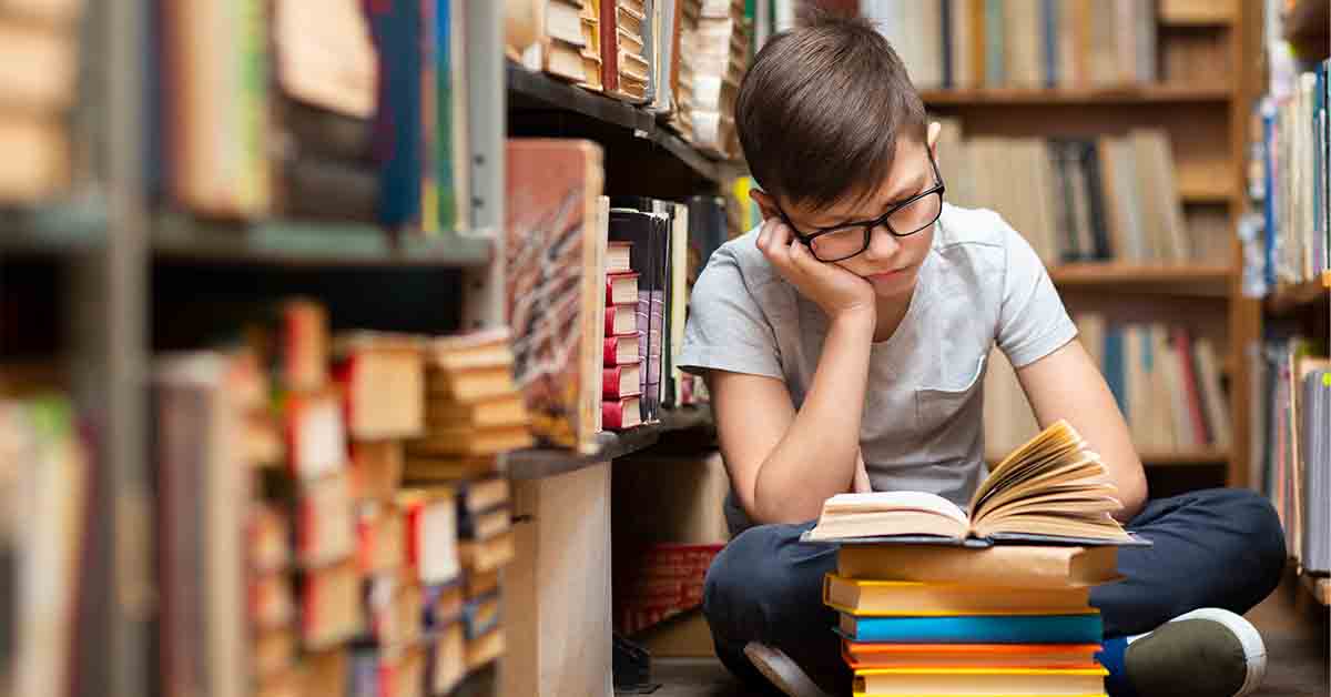 boy at library reading