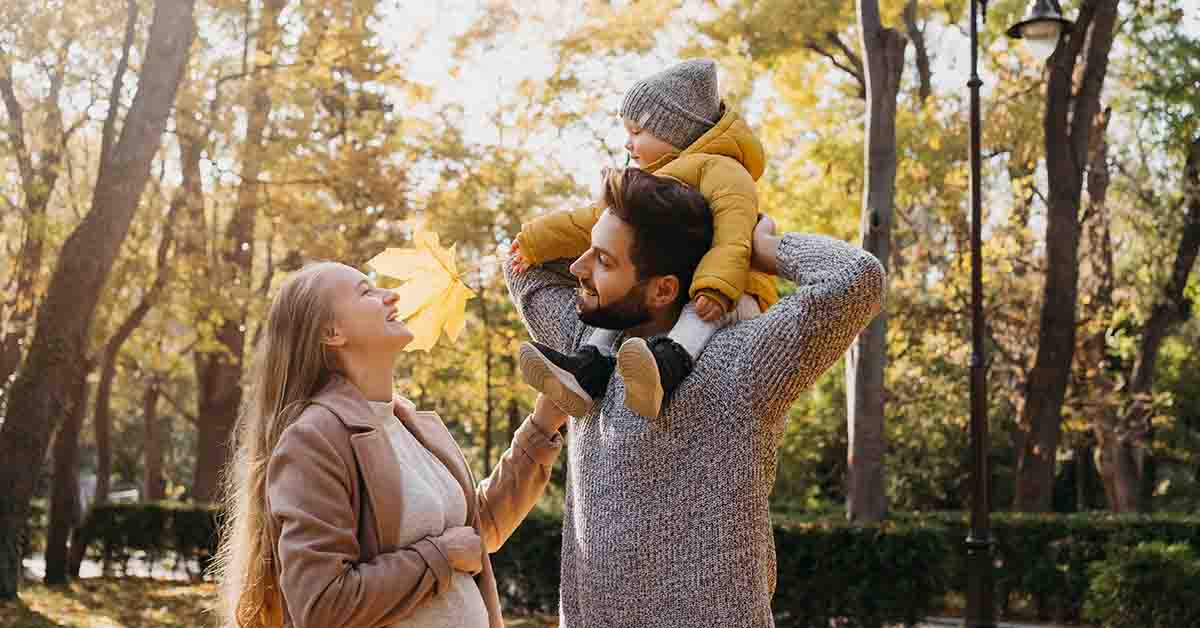 Happy dad and mom with baby outdoors