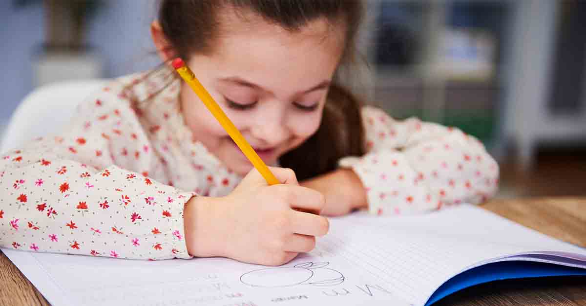 Girl's hand writing in her notebook