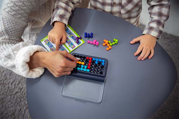 mother and kid playing with magnetic toys 