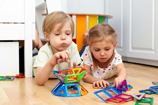 Young friends playing magnetic toys 