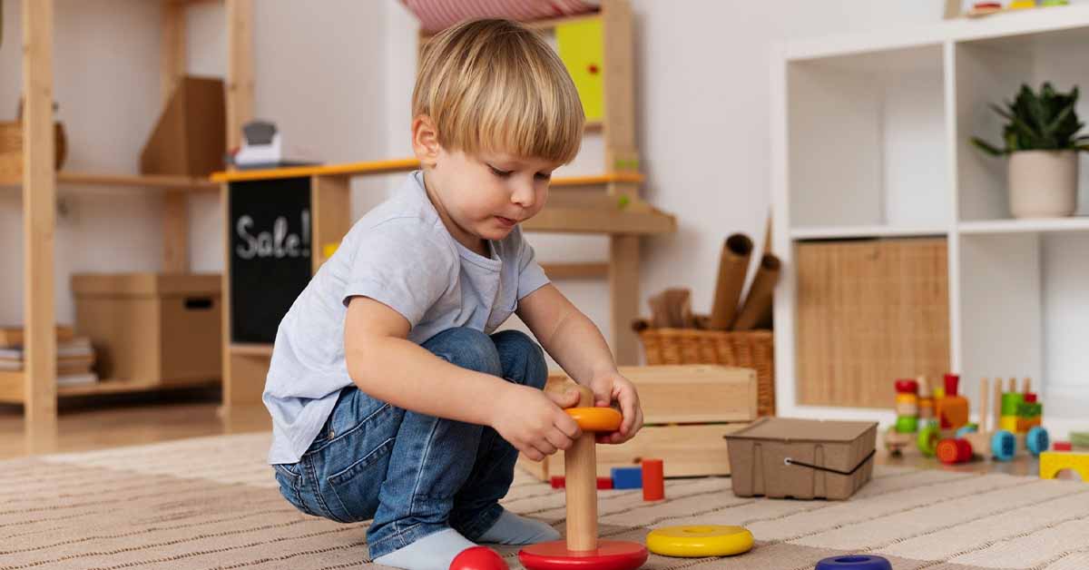 cute kid playing with wooden toy