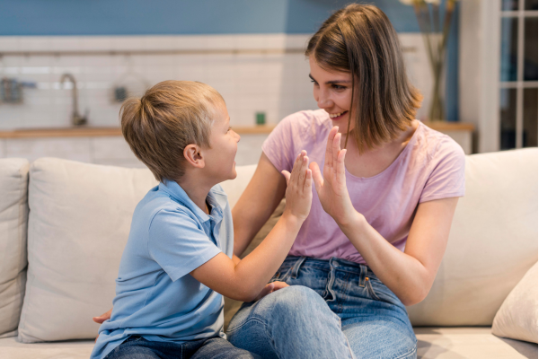 A mom high-fiving her son