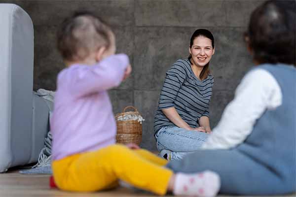 Mother watching her children playing