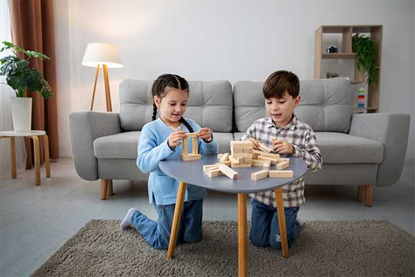 Girl and boy playing with building blocks 
