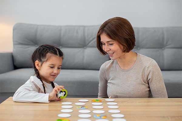 Mother and daughter playing with board game 