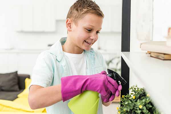 Smiley boy watering plant