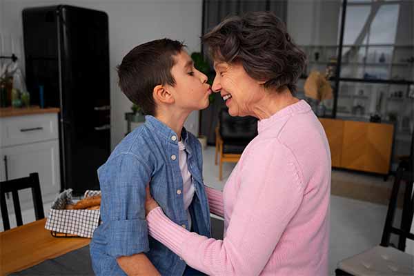 Medium shot grandson kissing grandmother showing gratitude 