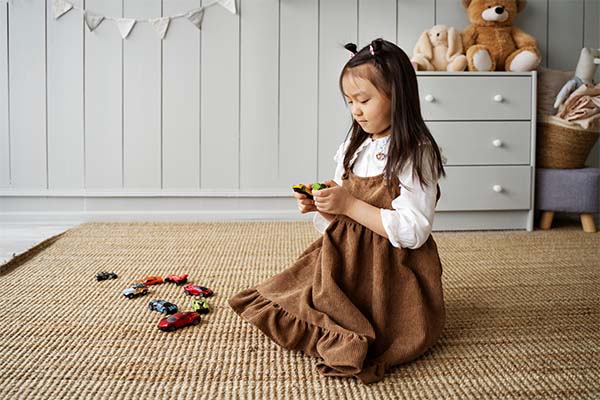 Girl is playing with toys in home