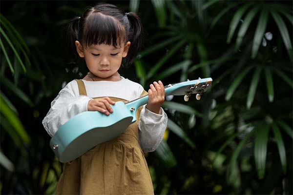 girl holding ukulele