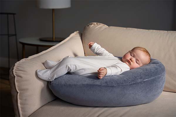 Cute baby on nursing pillow