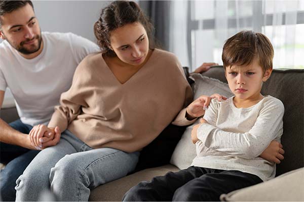 parents and sad kid at therapy