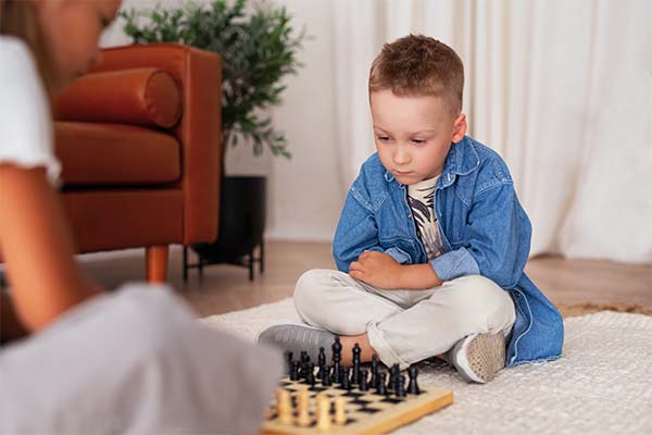 screen-free activities: Kid playing chess 