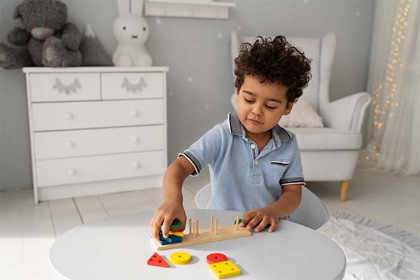 Child playing with shape toys 