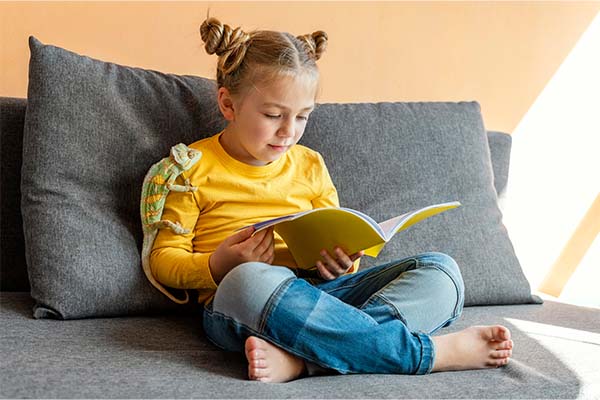 small girl sensory reading with chameleon