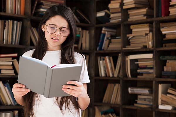  beautiful girl reading a sensory book