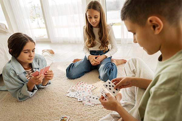 Cousins spending time together at home and playing cards