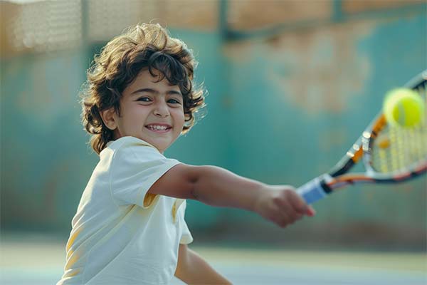 young boy practicing tennis