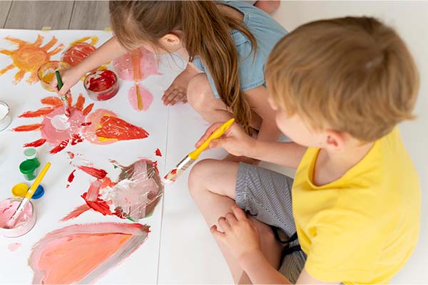 Boy and girl doing painting by developing hobbies 