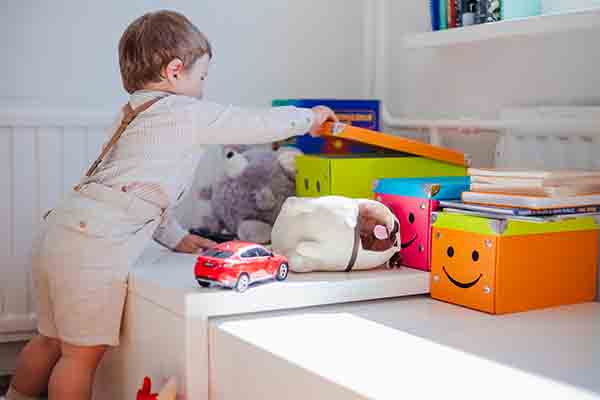 Little boy opening box with toys