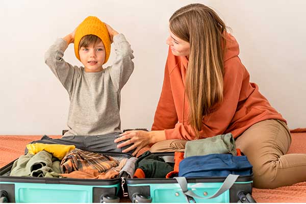 Mother and son packing for family outing 