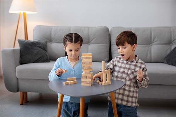 A girl and a boy playing with Speech & Language Development Toys