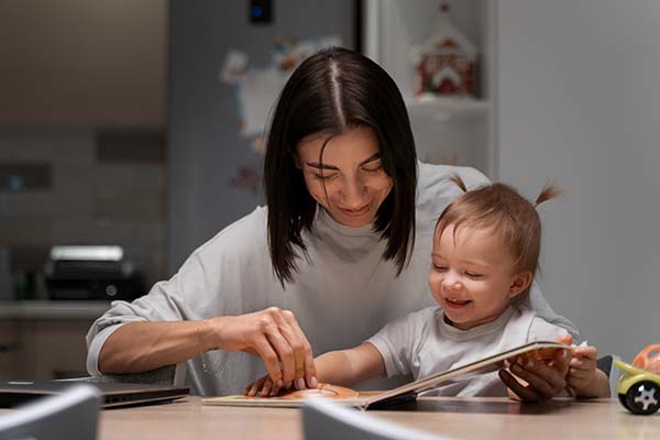mother and baby with book