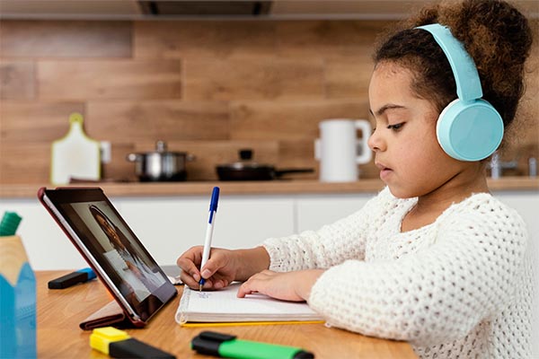 little girl during online school with tablet