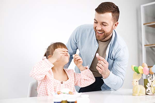 Father giving candy to his daughter