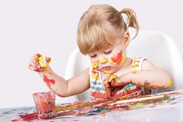 little girl painting and playing