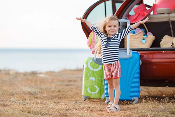 Happy little girl going to travel