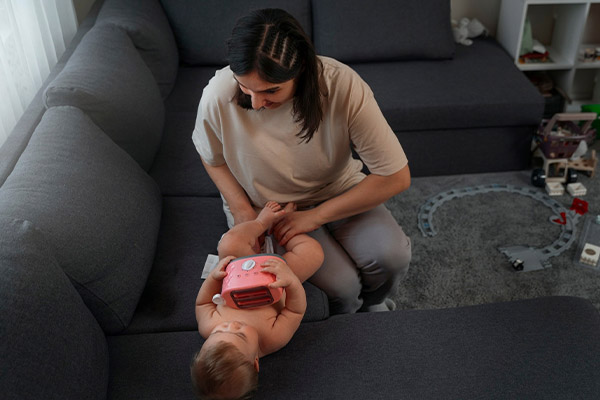 mother changing diaper of baby