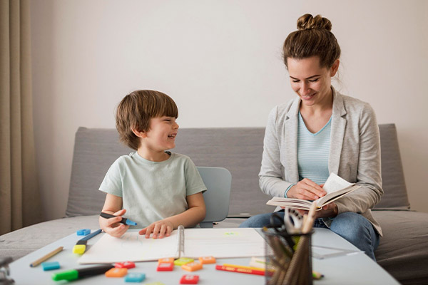 child being tutored at home by woman using speech therapy toys 