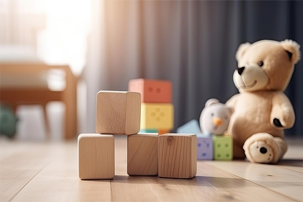 Wooden toy blocks on wooden table in the children's room 