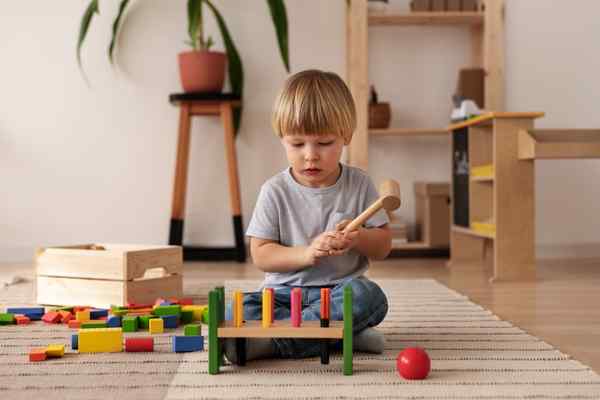 child playing with colorful wooden toys