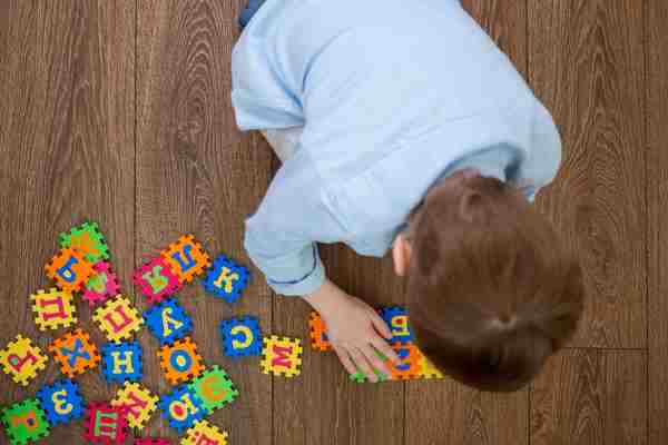 A boy playing with an alphabet game