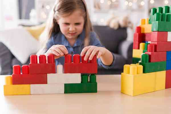 Girl building something using building blocks
